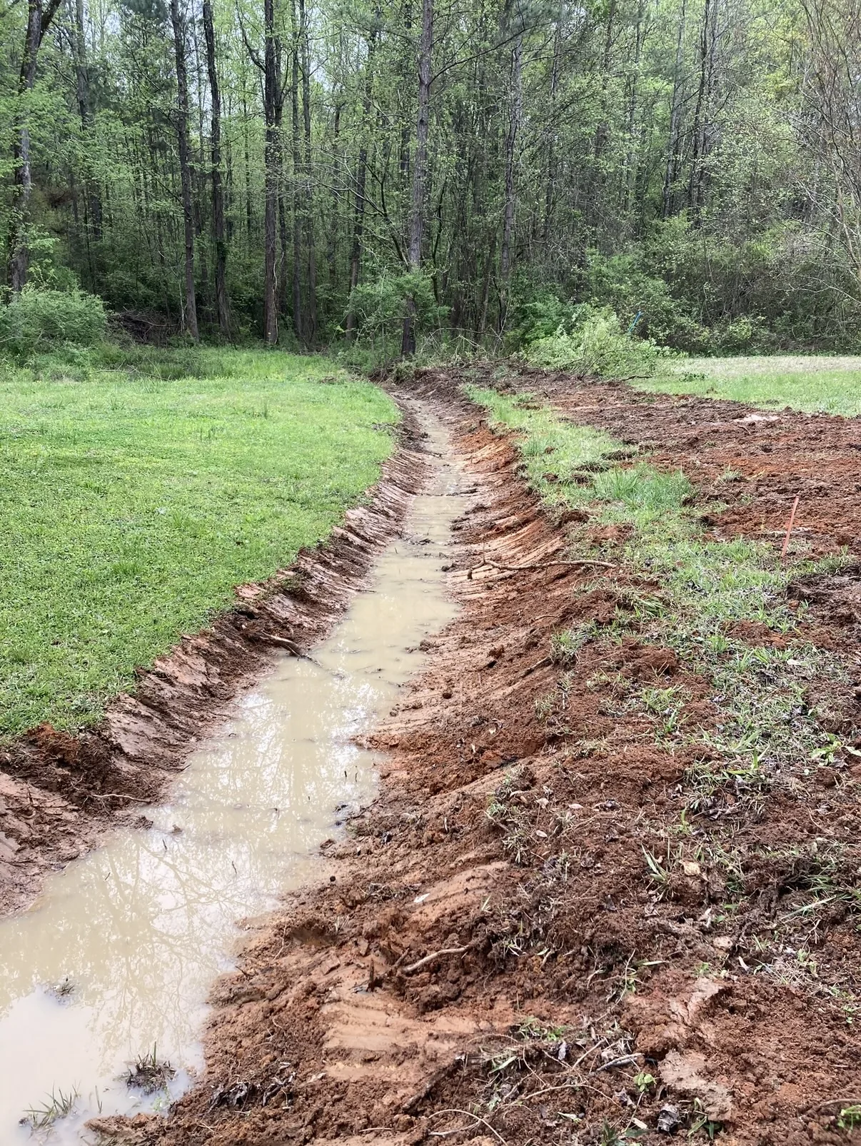 Drainage trench formed and graded